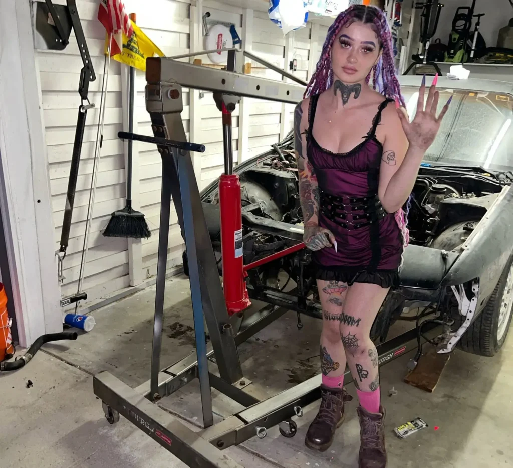 Peyton working as a mechanic posing for a photo
