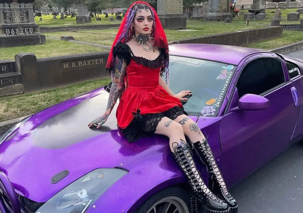 Peyton working as a mechanic posing for a photo